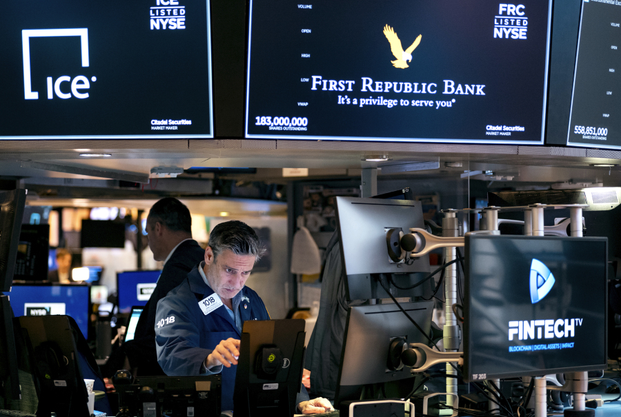 Traders work on the floor at the New York Stock Exchange in New York, Monday, March 13, 2023.