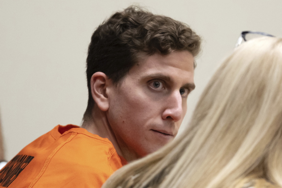 FILE - Bryan Kohberger, left, who is accused of killing four University of Idaho students in November 2022, looks toward his attorney, public defender Anne Taylor, right, during a hearing in Latah County District Court, Jan. 5, 2023, in Moscow, Idaho. Law enforcement officials seized dark clothing, medical gloves, a flashlight and other items from a Pennsylvania home where they arrested Kohberger, a graduate student charged with stabbing four University of Idaho students to death, according to newly unsealed court documents. The records were made public Tuesday, Feb. 28. (AP Photo/Ted S.