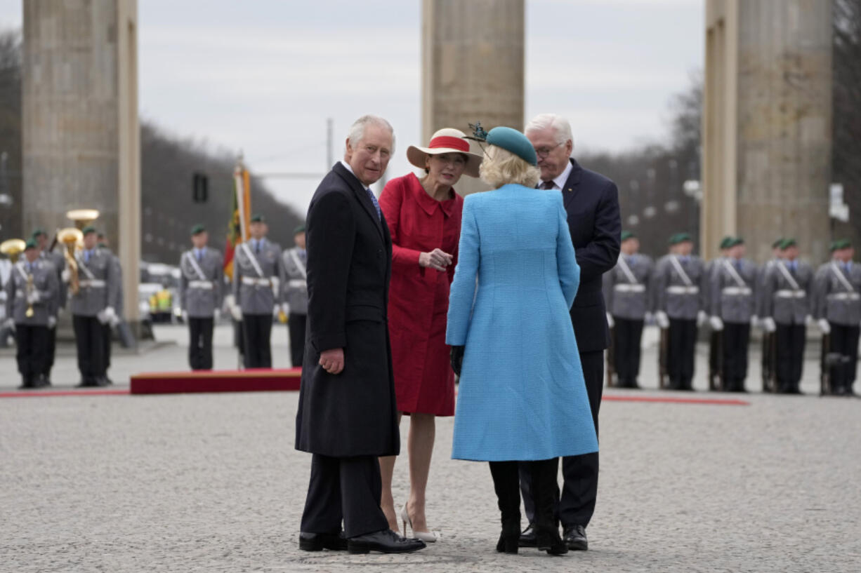 German President Frank-Walter Steinmeier and his wife Elke Buedenbender welcome Britain's King Charles III and Camilla, the Queen Consort, in front of the Brandenburg Gate in Berlin, Wednesday, March 29, 2023. King Charles III arrived Wednesday for a three-day official visit to Germany.