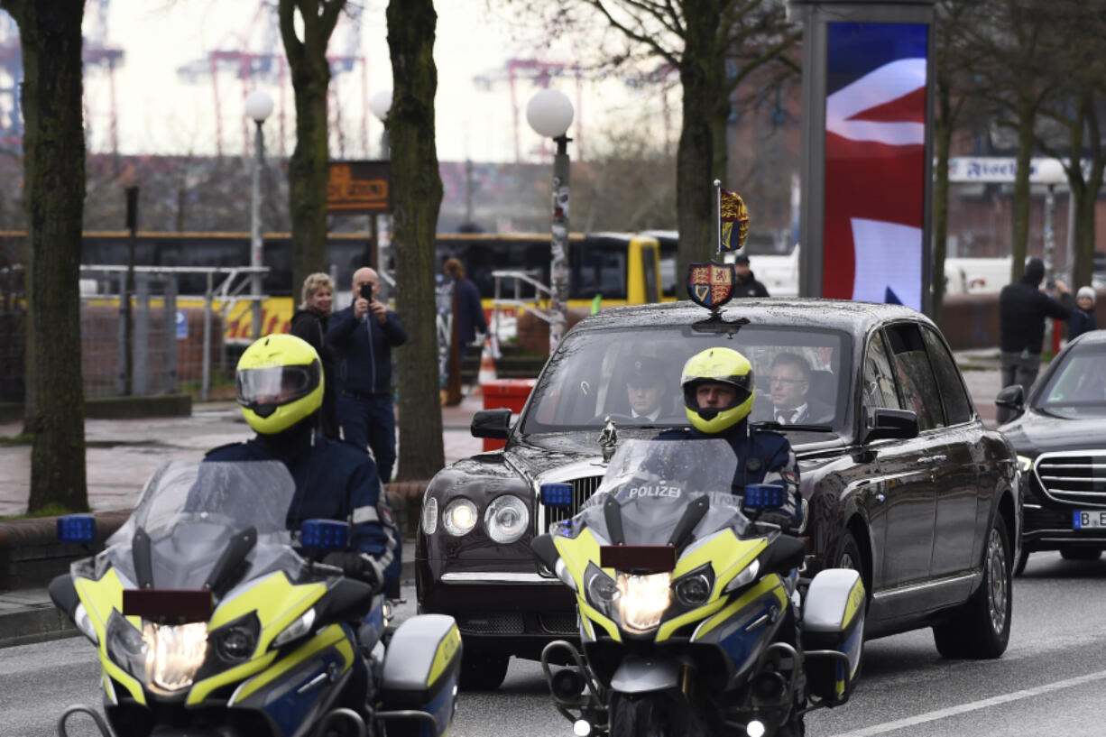 Motorcade with Britain's King Charles III, and Camilla, the Queen Consort, drives through the streets of Hamburg, Germany, Friday, March 31, 2023. King Charles III arrived Wednesday for a three-day official visit to Germany.