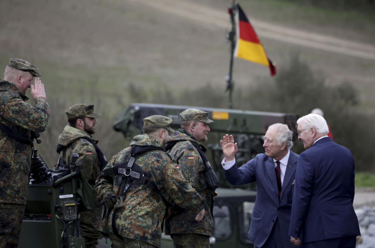 Britain's King Charles III, 2nd right, talks with soldiers during his visit at the 130th German-British Pioneer Bridge Battalion military unit in Finowfurt, eastern Germany, on Thursday, March 30, 2023.(Jens Schlueter /Pool Photo via AP)