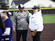 Former Heritage athletic director Leta Meyer, right, talks with Kelso coach Dean Sorenson prior to the first Heritage fastpitch softball game played at the school's new turfed field facility on Tuesday, March 14, 2023 (Tim Martinez/The Columbian)
