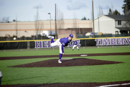 Heritage pitcher Ethan Scott delivers a pitch during the Timberwolves' first baseball game at Heritage's new turf field facility on Tuesday, March 14, 2023.