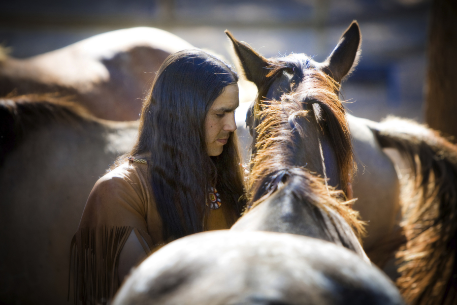 In this photo provided by Sacred Way Sanctuary, He Stalks One spends time with a horse in Alabama in 2021. These horses are the descendants of those that accompanied the Cherokee, Choctaw, Muscogee, Chickasaw and Seminole Peoples on forced removals, referred to as the "Trail of Tears." In a study published Thursday, March 30, 2023, in the journal Science, a new analysis of horse bones gathered from museums across the Great Plains and northern Rockies has revealed that horses were present in the grasslands by the early 1600s, an earlier date than many written histories suggest.