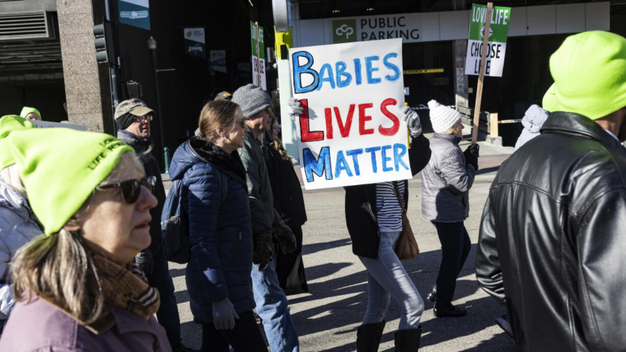 People walk to the Idaho Capitol Building for the Boise March for Life rally on Jan. 21. A rural hospital in Sandpoint, Idaho, will stop delivering babies, citing recently passed state laws criminalizing medical care, among other reasons.