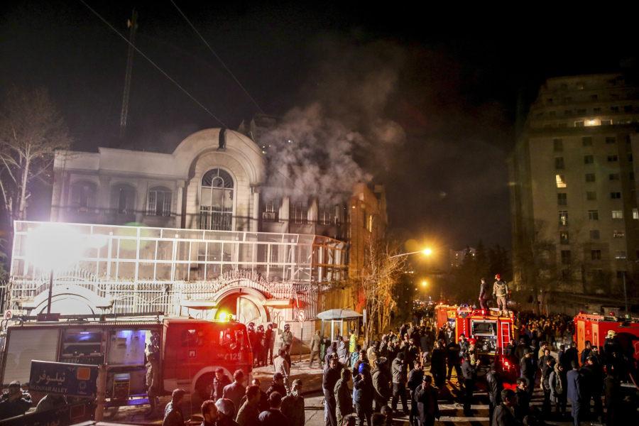FILE - Smoke rises as Iranian protesters set fire to the Saudi embassy in Tehran, Sunday, Jan. 3, 2016. Iran and Saudi Arabia have agreed to reestablish diplomatic relations and reopen embassies after years of tensions. The two countries released a joint communique about the deal on Friday, March 10, 2023 with China, which apparently brokered the agreement.