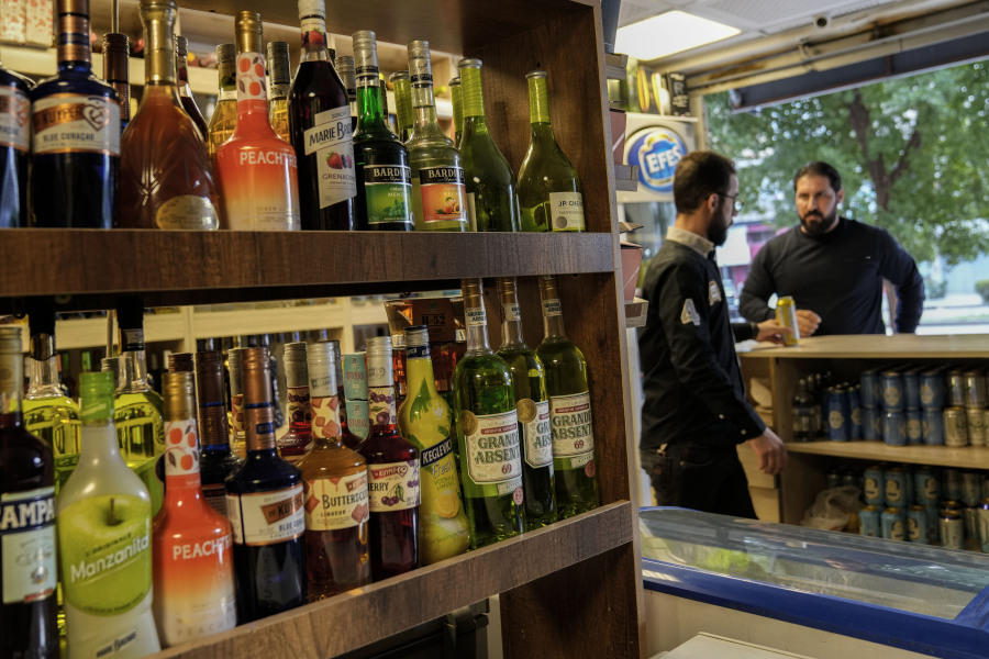 People buy alcohol in a liquor store in Baghdad, Iraq, Thursday, March 9, 2023. The Iraqi government started enforcing a 2016 ban on alcoholic beverages this month, although many liquor shops remained open in Baghdad.