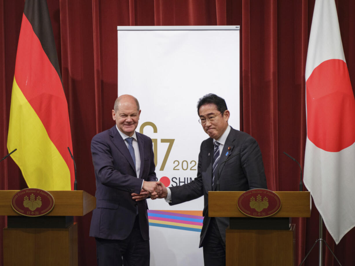 German Chancellor Olaf Scholz, left, and Japan's Prime Minister Fumio Kishida shake hands after summit at prime minister's official residence in Tokyo, Saturday, March 18, 2023.(Nicolas Datiche/Pool Photo via AP)