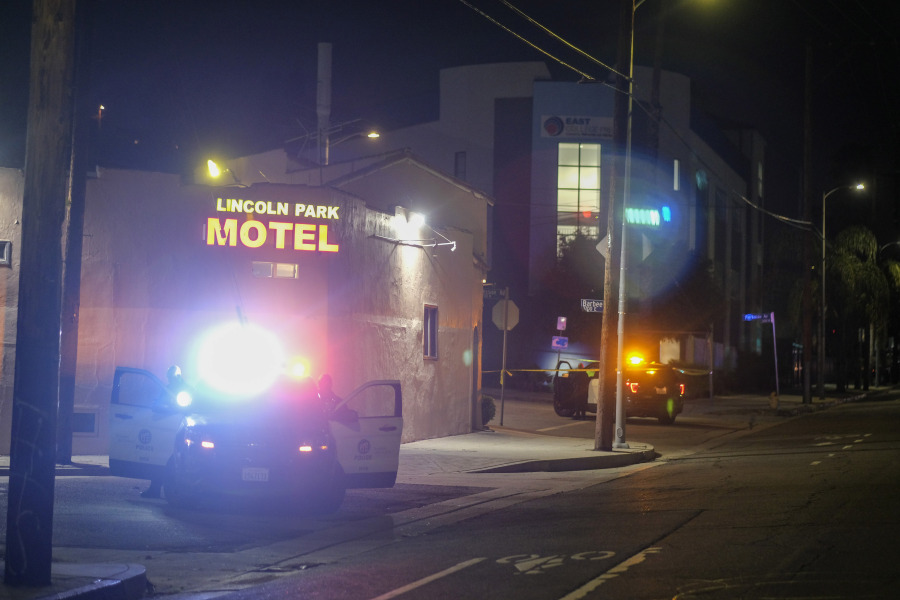 Police officers guard near a crime scene where three Los Angeles police officers were shot, Wednesday, March 8, 2023, in Los Angeles. Police said the officers were hospitalized and in stable condition. (AP Photo/Ringo H.W.