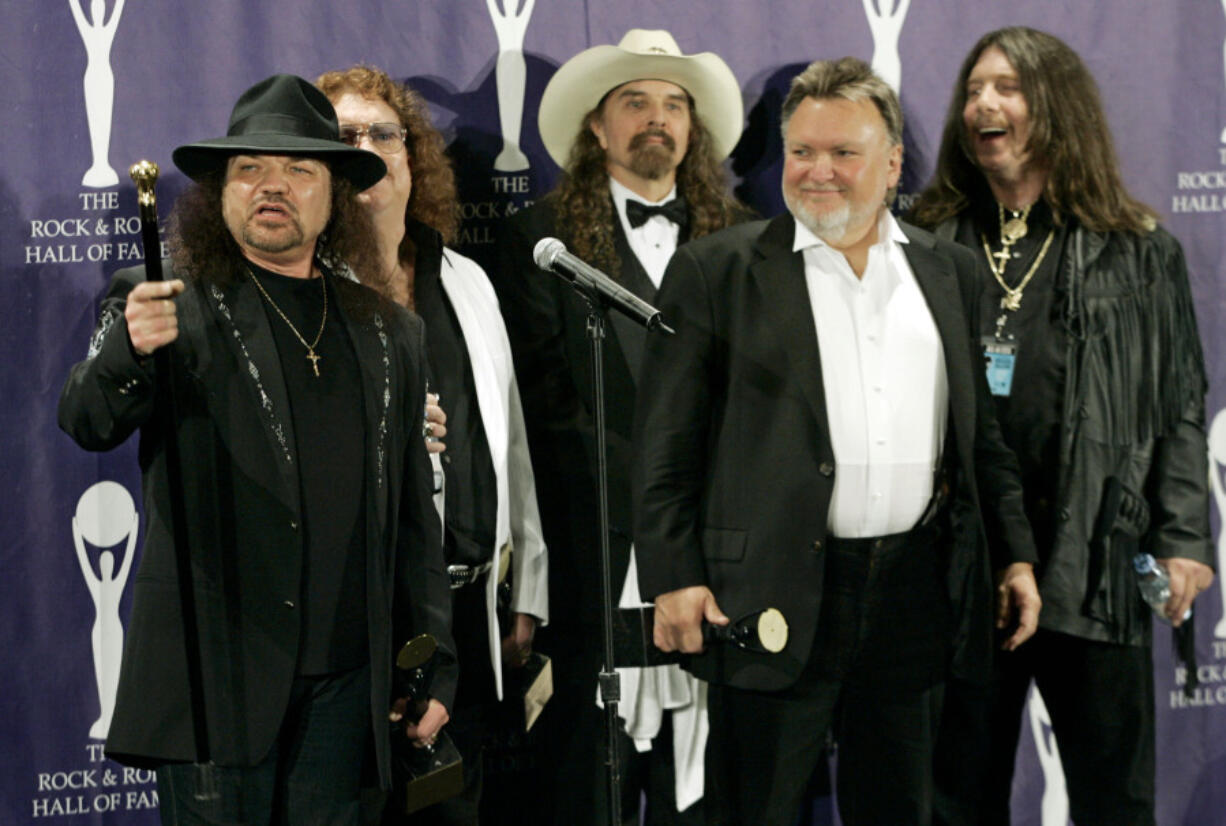 The band Lynyrd Skynyrd, from left, Gary Rossington, Billy Powell, Artimus Pyle, Ed King and Bob Burns appear backstage after being inducted at the Rock and Roll Hall of Fame in New York on March 13, 2006. Rossington, the iconic band's last surviving cofounder, who died March 5, was also perhaps the last flag pole in a once powerful part of American culture: Southern rock.