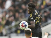 Los Angeles FC forward Kwadwo Opoku (22) misses a header under pressure by Portland Timbers defender Claudio Bravo (5) during the second half of an MLS soccer match, Saturday, March 4, 2023, in Los Angeles. The LAFC won 3-2. (AP Photo/Jae C.
