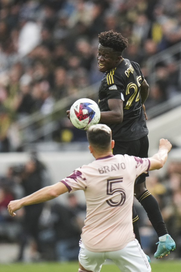 Los Angeles FC forward Kwadwo Opoku (22) misses a header under pressure by Portland Timbers defender Claudio Bravo (5) during the second half of an MLS soccer match, Saturday, March 4, 2023, in Los Angeles. The LAFC won 3-2. (AP Photo/Jae C.