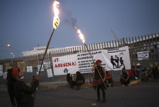 Activists protest outside a migrant detention center in Ciudad Juarez, Mexico, Wednesday, March 29, 2023, a day after dozens of migrants died in a fire at the center.