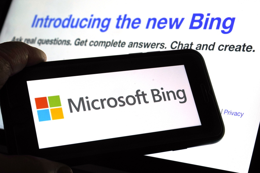 FILE - The Microsoft Bing logo and the website's page are shown in this photo taken in New York on Tuesday, Feb. 7, 2023.  Microsoft is ready to take its new Bing chatbot mainstream '?? less than a week after making major fixes to stop the artificially intelligent search engine from going off the rails. The company said Wednesday, Feb. 22,  it is bringing the new AI technology to its Bing smartphone app, as well as the app for its Edge internet browser.