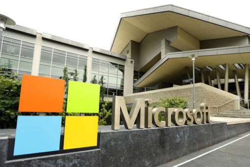 FILE - In this July 3, 2014, file photo, the Microsoft Corp. logo is displayed outside the Microsoft Visitor Center in Redmond, Wash. Microsoft is infusing generative AI tools into its Office software, including Word, Excel and Outlook emails. The company said Thursday, March 16, 2023 the new feature, named Copilot, is a processing engine that will allow users to do things like summarize long emails, draft stories in Word and animate slides in PowerPoint. (AP Photo/Ted S.