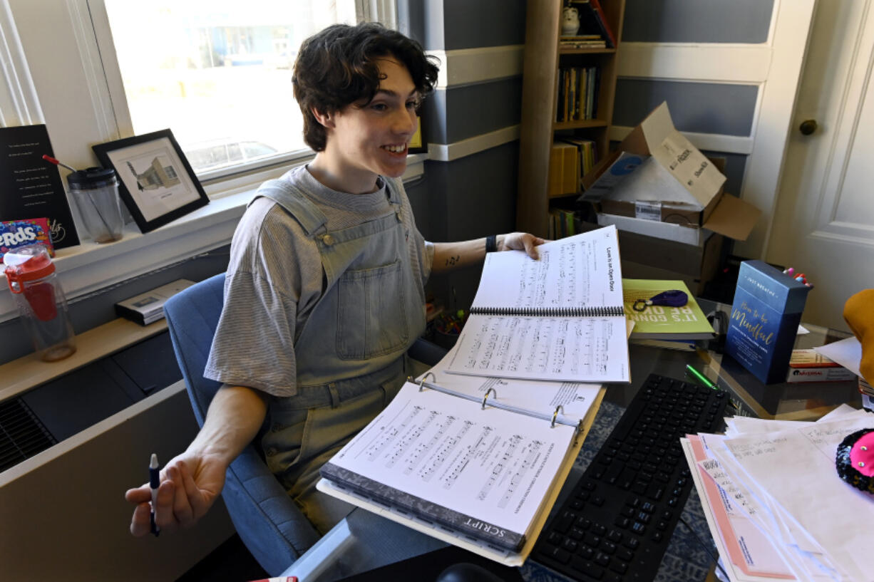 Grayson Hart, who directs a youth theater program, reviews sheet music at the Ned R. McWherter West Tennessee Cultural Arts Center in Jackson, Tenn., on March 4. Hart is among thousands of young people who came of age during the pandemic but didn't go to college.