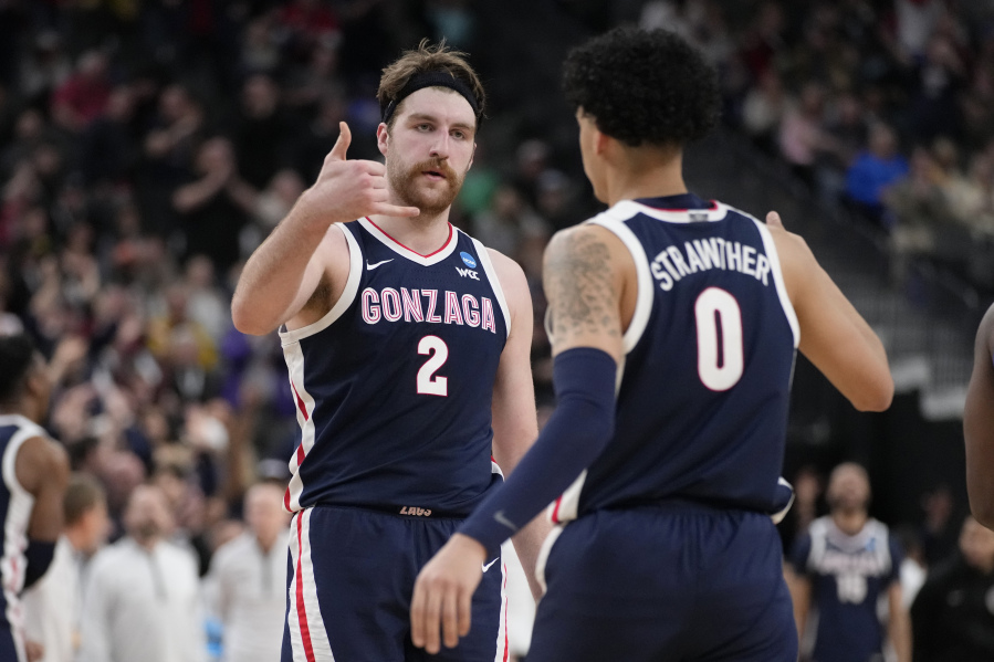 Gonzaga's Drew Timme (2) and Julian Strawther (0) celebrate in the second half of a Sweet 16 college basketball game against UCLA in the West Regional of the NCAA Tournament, Thursday, March 23, 2023, in Las Vegas.