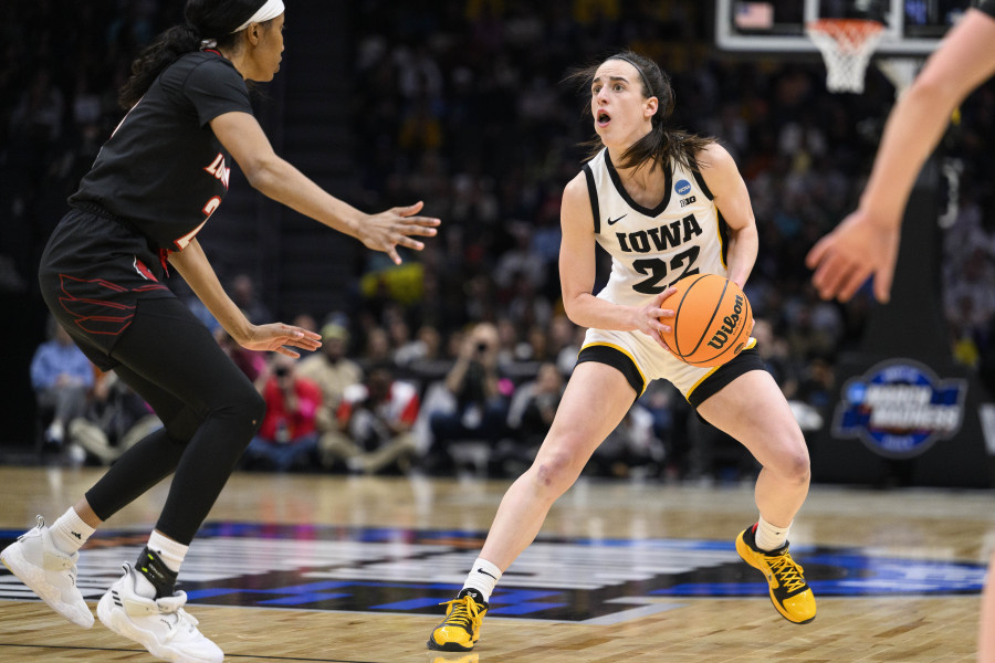 Iowa guard Caitlin Clark (22) steps back before shooting a 3-point basket as Louisville guard Morgan Jones (24) closes in on defense during the second quarter of a Sweet 16 college basketball game of the NCAA Tournament in Seattle, Sunday, March 26, 2023.