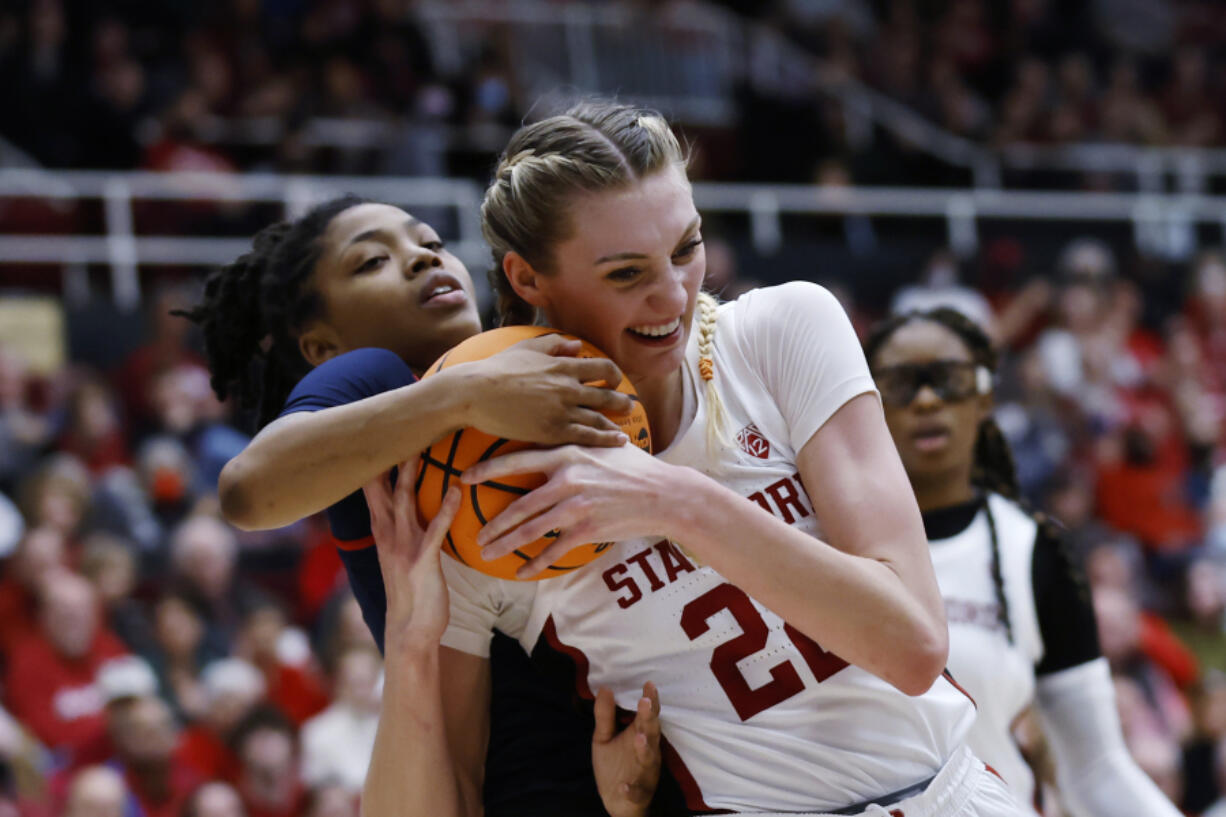 Mississippi guard Angel Baker, left, and Stanford forward Cameron Brink, right, vie for the ball during the first half of a second-round college basketball game in the women's NCAA Tournament, Sunday, March 19, 2023, in Stanford, Calif.