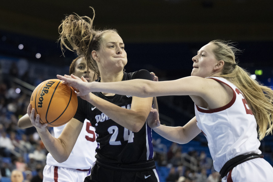 Portland guard Maisie Burnham, left, protects the ball from Oklahoma guard Aubrey Joens during the second half of a first-round college basketball game in the women's NCAA Tournament, Saturday, March 18, 2023, in Los Angeles.