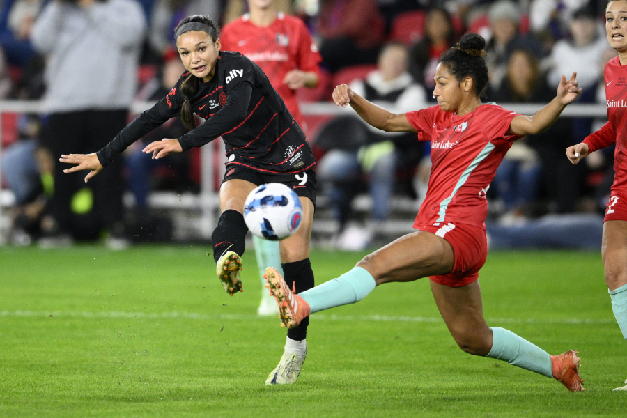 FILE - Portland Thorns FC forward Sophia Smith, left, kicks the ball against Kansas City Current defender Addisyn Merrick, right, during the first half of the NWSL championship soccer match, Saturday, Oct. 29, 2022, in Washington. Portland is also among the favorites this season because of a loaded roster that includes U.S. national team players like Sophia Smith, Crystal Dunn and Becky Sauerbrunn.