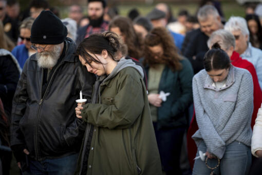 People pray during a community vigil held for the people killed during the Covenant School shooting on Tuesday, March 28, 2023, in Mt. Juliet, Tenn.