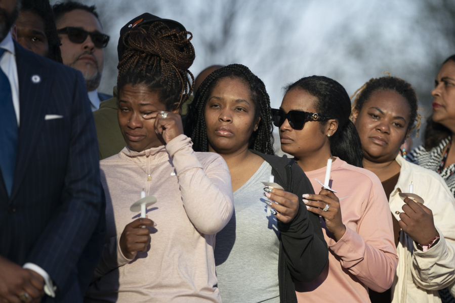 A mourner wipes away a  tear during the Nashville Remembers candlelight vigil to mourn and honor the victims of The Covenant School mass shooting at Public Square Park Wednesday, March 29, 2023 in Nashville, Tenn.