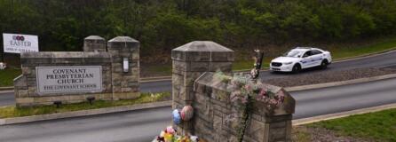 A make shift memorial is seen at the entry to Covenant School with a police car guarding, on Tuesday, March 28, 2023, in Nashville, Tenn. The former student who shot through the doors of the Christian elementary school and killed three children and three adults had drawn a detailed map of the school.