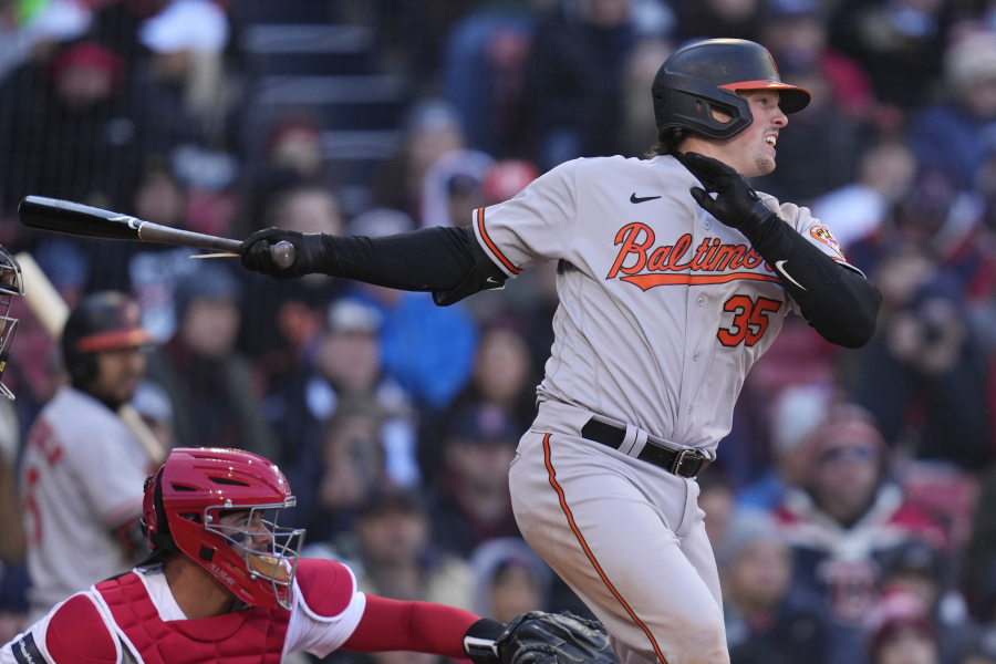 Baltimore Orioles' Adley Rutschman watches the flight of his RBI single in the seventh inning of an opening day baseball game against the Boston Red Sox at Fenway Park, Thursday, March 30, 2023, in Boston.