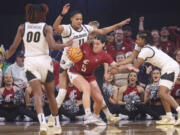 Washington State guard Charlisse Leger-Walker (5) is defended by Colorado center Quay Miller (11) and guard Tameiya Sadler, right, during the first half of an NCAA college basketball game in the semifinals of the Pac-12 women's tournament Friday, March 3, 2023, in Las Vegas.