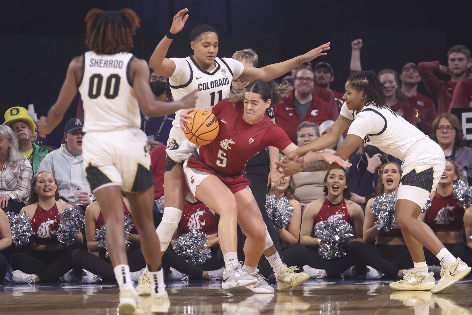 Washington State guard Charlisse Leger-Walker (5) is defended by Colorado center Quay Miller (11) and guard Tameiya Sadler, right, during the first half of an NCAA college basketball game in the semifinals of the Pac-12 women's tournament Friday, March 3, 2023, in Las Vegas.