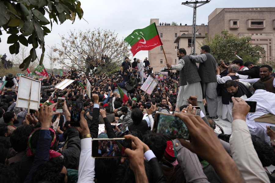 Supporters of former Pakistani Prime Minister Imran Khan move with a vehicle, center, carrying their leader Khan following his court appearance, in Islamabad, Pakistan, Tuesday, Feb. 28, 2023. A Pakistani court approved bail for Khan after he appeared before a judge in Islamabad amid tight security, officials said, months after police filed terrorism charges against the country's popular opposition leader for inciting people to violence.
