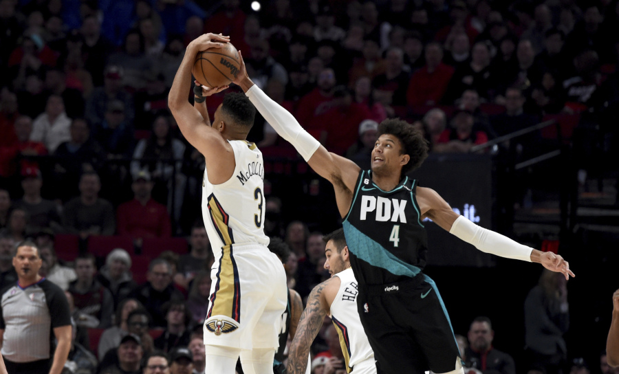 Portland Trail Blazers guard Matisse Thybulle, right, blocks a shot by New Orleans Pelicans guard CJ McCollum during the first half of an NBA basketball game in Portland, Ore., Wednesday, March 1, 2023.