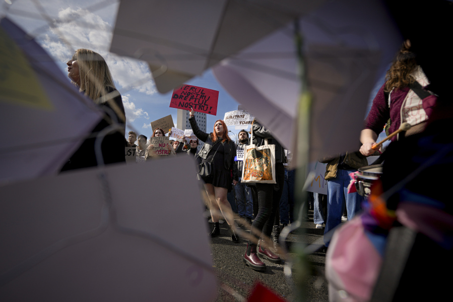 Women take part in a rally dubbed "My Uterus is not your profit" to raise awareness on the difficulties of getting an abortion in a state hospital, during International Women's Day outside the government headquarters in Bucharest, Romania, Wednesday, March 8, 2023.