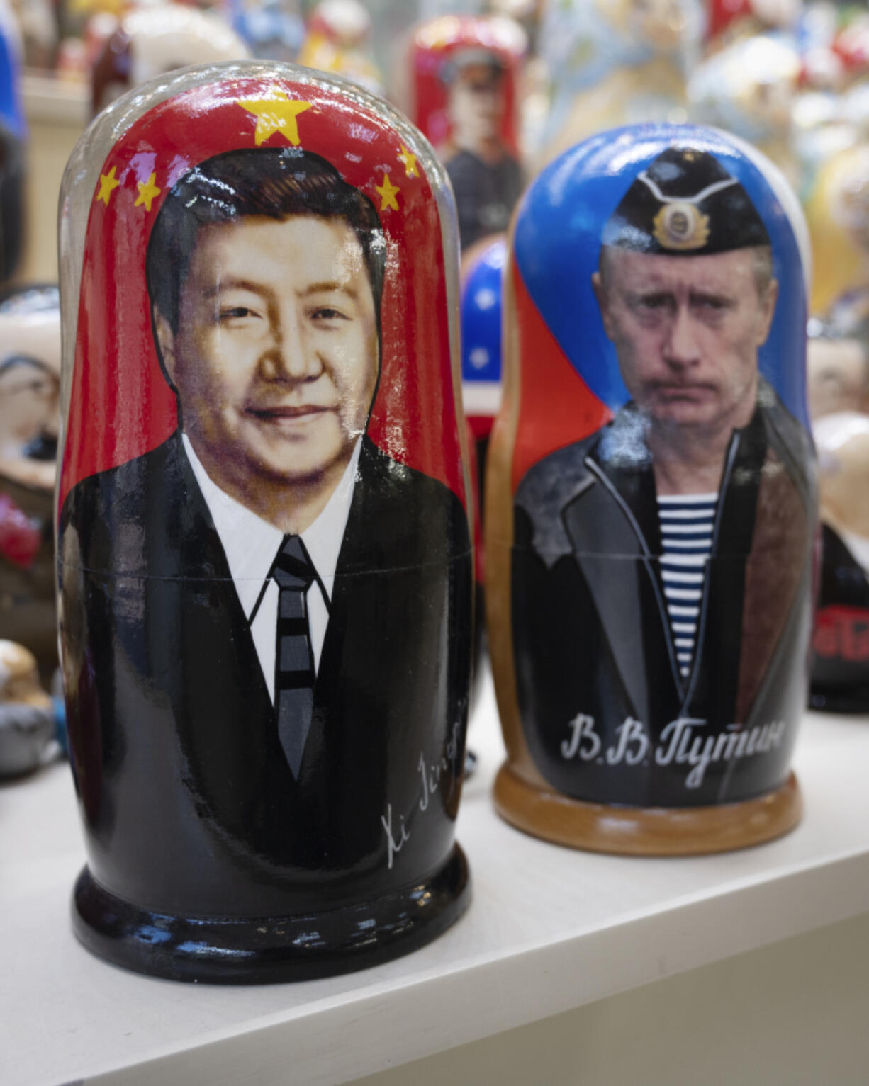 Russian matryoshka dolls with portraits of the Chinese President Xi Jinping, left, and Russian President Vladimir Putin are displayed among others for sale at a souvenir shop in Moscow, Russia, Tuesday, March 21, 2023. Chinese President Xi Jinping arrived in neighbouring Russia for a three-day trip for the talks with Russian President Vladimir Putin.