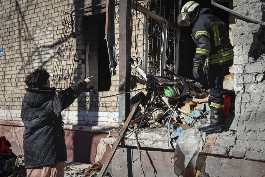 Ukrainian Emergency Service rescuers work on a building damaged by shelling in Kramatorsk, Donetsk region, Ukraine, Tuesday, March 14, 2023. One person has been killed, according to local authorities.