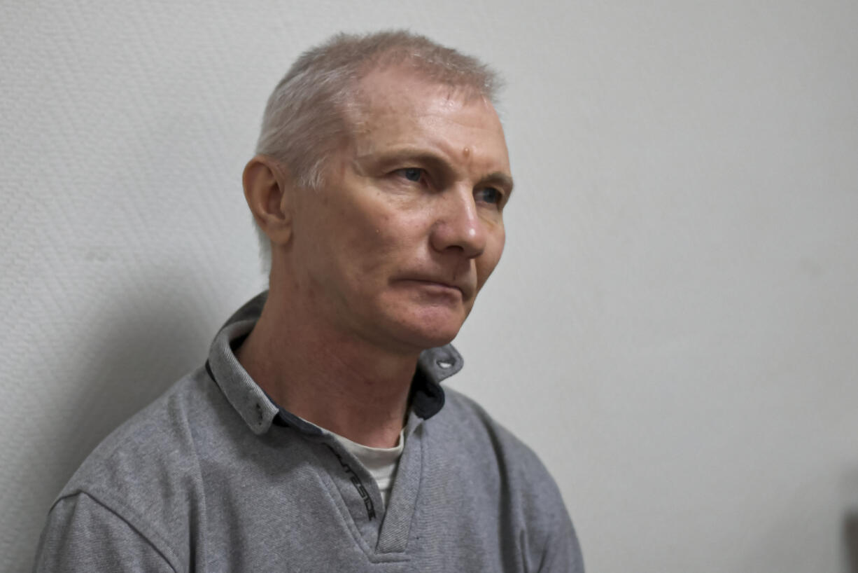 Alexei Moskalyov sits in a courtroom in Yefremov, Tula region, some 300 kilometers (186 miles) south of Moscow, Russia, Monday, March 27, 2023. A court in Russia on Tuesday convicted a single father over social media posts criticizing the war in Ukraine and sentenced him to two years in prison -- a case brought to the attention of authorities by his daughter's drawings against the invasion at school, according to the man's lawyer and local activists. The 54-year-old Moskalyov, a single father of a 13-year-old daughter, was accused of repeatedly discrediting the Russian army, a criminal offense in accordance to a law Russian authorities adopted shortly after sending troops into Ukraine.