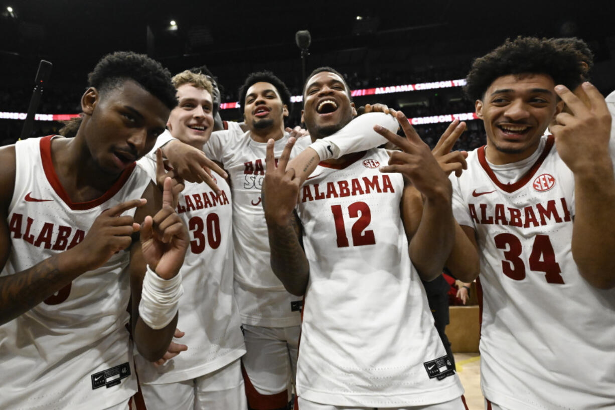 Alabama players celebrate on the court after an NCAA college basketball game against Texas A&M in the finals of the Southeastern Conference Tournament, Sunday, March 12, 2023, in Nashville, Tenn.