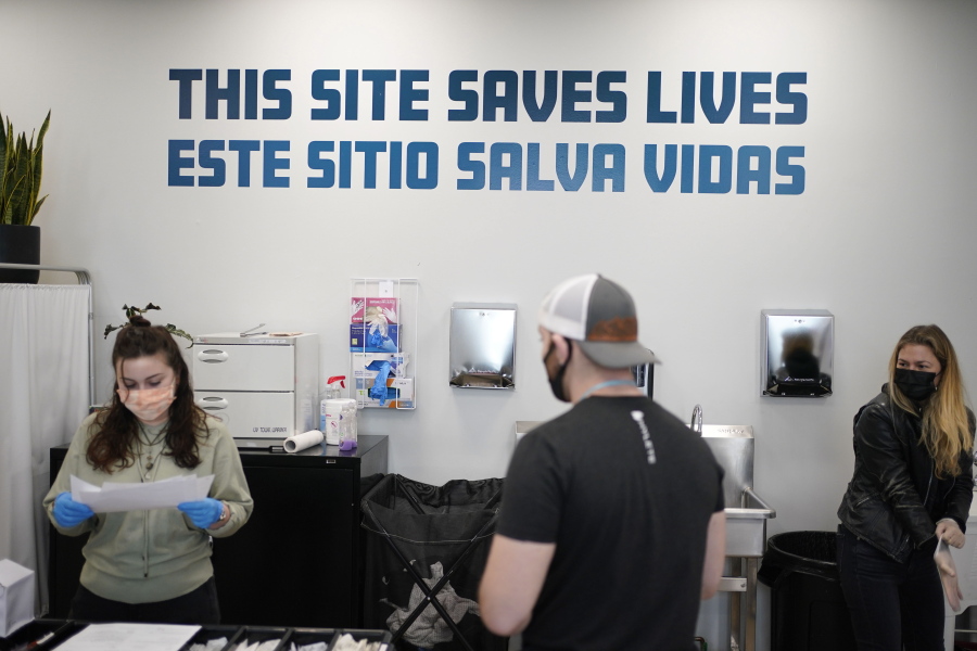 FILE - A sign on the wall reads "This site save lives" in Spanish and English at an overdose prevention center at OnPoint NYC in New York, Feb. 18, 2022. Across the U.S., drug overdoses killed an estimated 100,000 people in 2021, according to federal health officials. That has pushed lawmakers in Colorado, New Mexico and Nevada to consider joining New York in allowing what are often called "overdose prevention centers" -- spaces where people can use illicit drugs under the supervision of trained staff who could reverse an overdose if necessary.