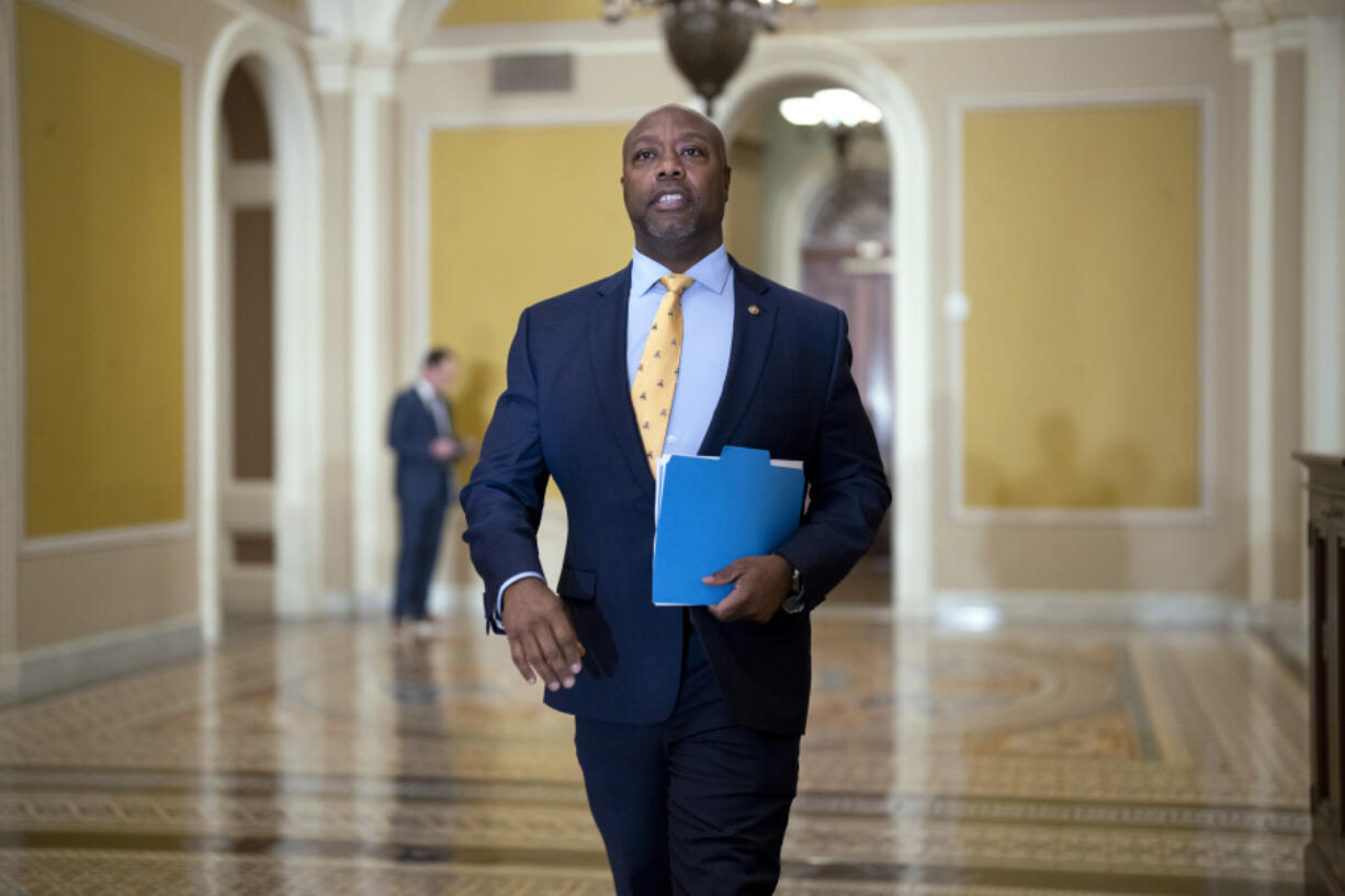 Sen. Tim Scott, R-S.C., walks past the chamber during the vote to confirm former Los Angeles Mayor Eric Garcetti as the next ambassador to India, more than a year and a half after he was initially selected for the post, at the Capitol in Washington, Wednesday, March 15, 2023. (AP Photo/J.