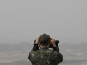A South Korean army soldier watches the North Korea side from the Unification Observation Post in Paju, South Korea, near the border with North Korea, Friday, March 24, 2023.
