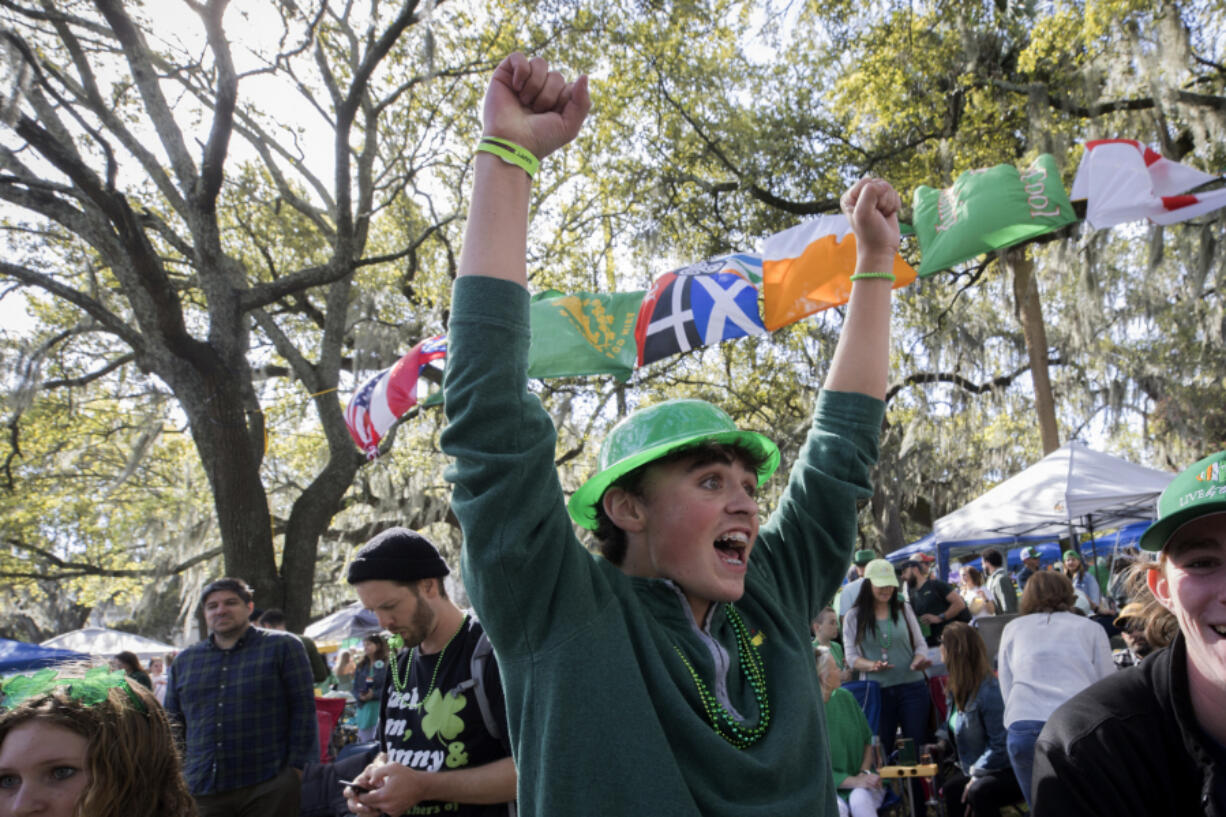Jack Stephans cheers while watching the St. Patrick's Day parade from the crowded oak-shaded square on Friday in downtown Savannah, Ga. (stephen b.