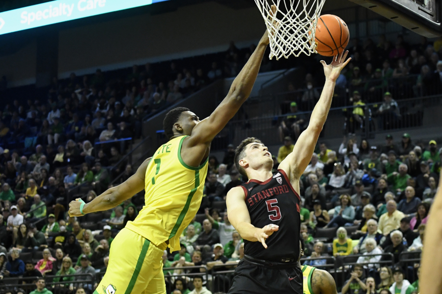 Oregon center N'Faly Dante (1) blocks the shot of Stanford guard Michael O'Connell (5) during the second half of an NCAA college basketball game Saturday, March 4, 2023, in Eugene, Ore.