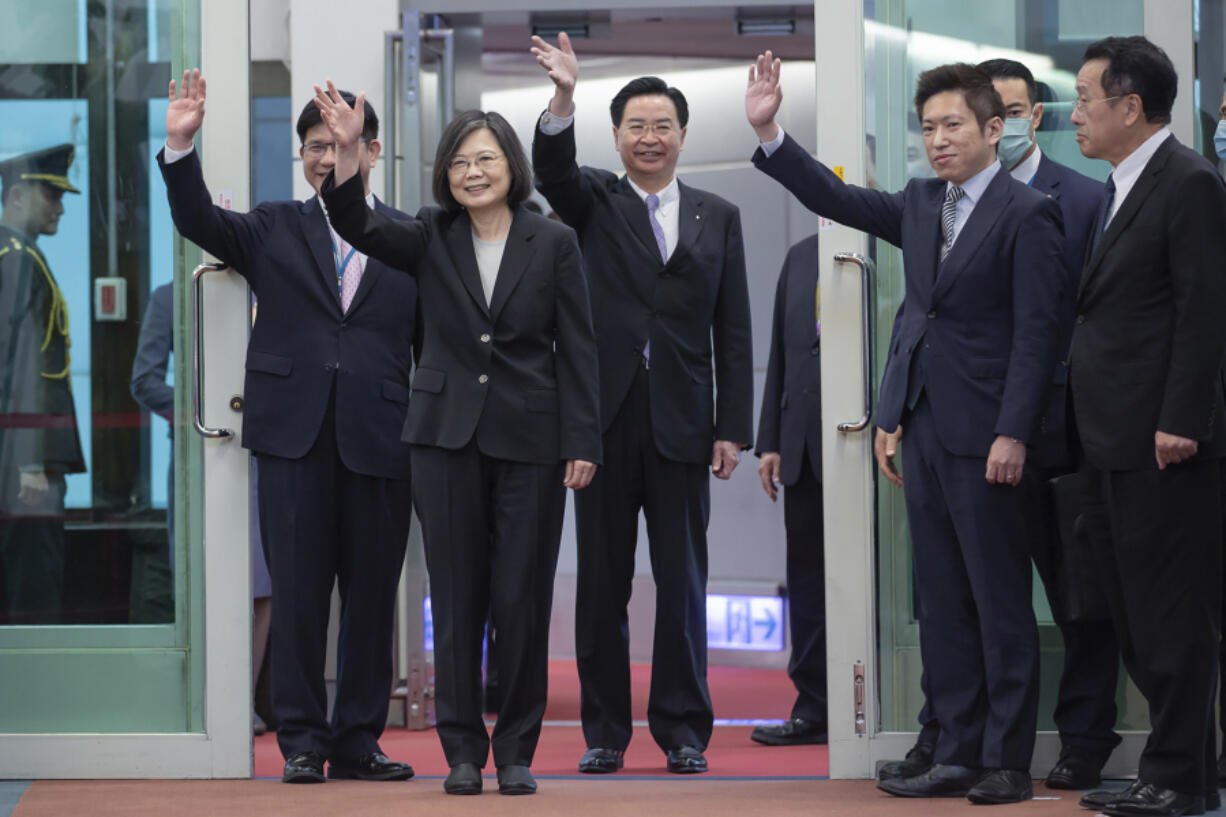 In this photo released by the Taiwan Presidential Office, Taiwan's Presidential office secretary general Lin Chia-lung, left, President Tsai Ing-wen, center, and Foreign Minister Joseph Wu wave before Tsai's departure on an overseas trip at Taoyuan International Airport in Taipei, Taiwan, Wednesday, March 29, 2023. China has threatened "resolute countermeasures" over a planned meeting between Taiwanese President Tsai Ing-wen and Speaker of the United States House Speaker Kevin McCarthy during an upcoming visit in Los Angeles by the head of the self-governing island democracy.