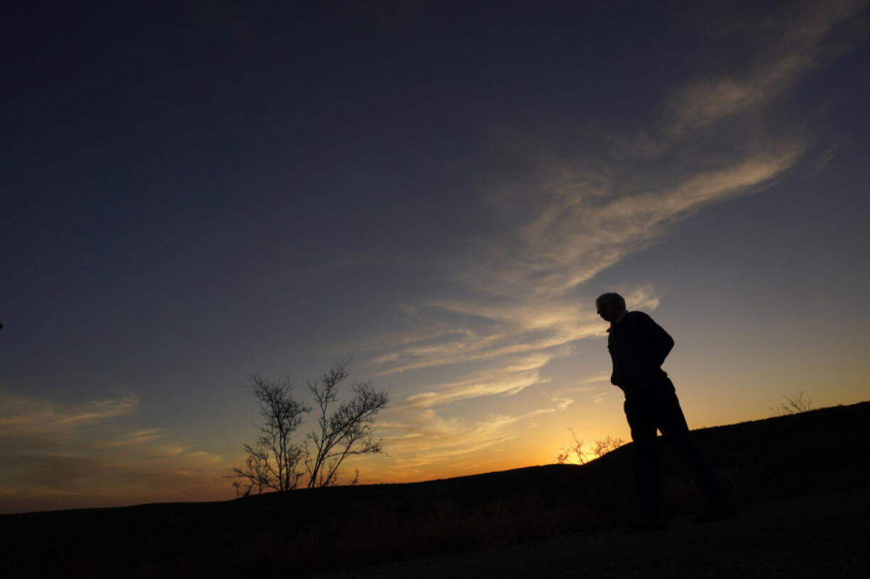 Rancher Randy Nunns watches sunset on the Monarch Ranch near Del Rio, Texas, Thursday, Feb. 16, 2023. Nunns and fellow landowners along the Devil's River argue that proposed wind turbines would kill birds, bats and disrupt monarch butterflies migrating to Mexico and impact ecotourism, a main source of income for many.