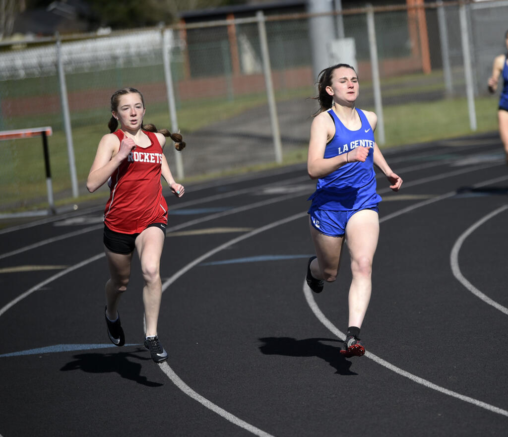 Casie Kleine of Castle Rock (left) and Shaela Bradley of La Center race the final turn in the girls 400 meters at the Tiger Relays at Battle Ground High School on Saturday, March 25, 2023. Kleine would go on to finish first just ahead of Bradley.