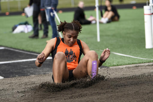 Faizah Ford of Battle Ground hits the sand on her way to winning the girls triple jump at the Tiger Relays at Battle Ground High School on Saturday, March 25, 2023.