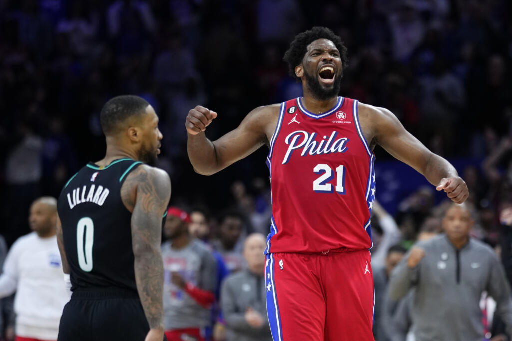 Philadelphia 76ers' Joel Embiid, right, reacts past Portland Trail Blazers' Damian Lillard after the 76ers won an NBA basketball game, Friday, March 10, 2023, in Philadelphia.