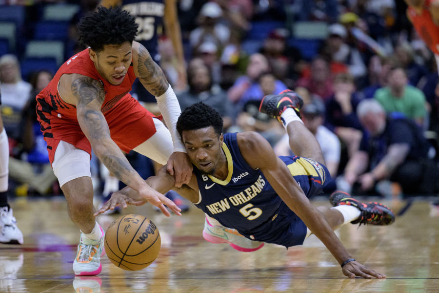 New Orleans Pelicans forward Herbert Jones (5) steals the ball from Portland Trail Blazers guard Anfernee Simons (1) in the first half of an NBA basketball game in New Orleans, Sunday, March 12, 2023.
