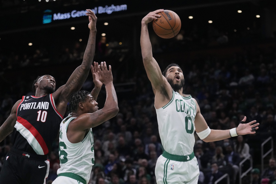 Boston Celtics forward Jayson Tatum (0) grabs a rebound against Portland Trail Blazers forward Nassir Little (10) during the second half of an NBA basketball game, Wednesday, March 8, 2023, in Boston.